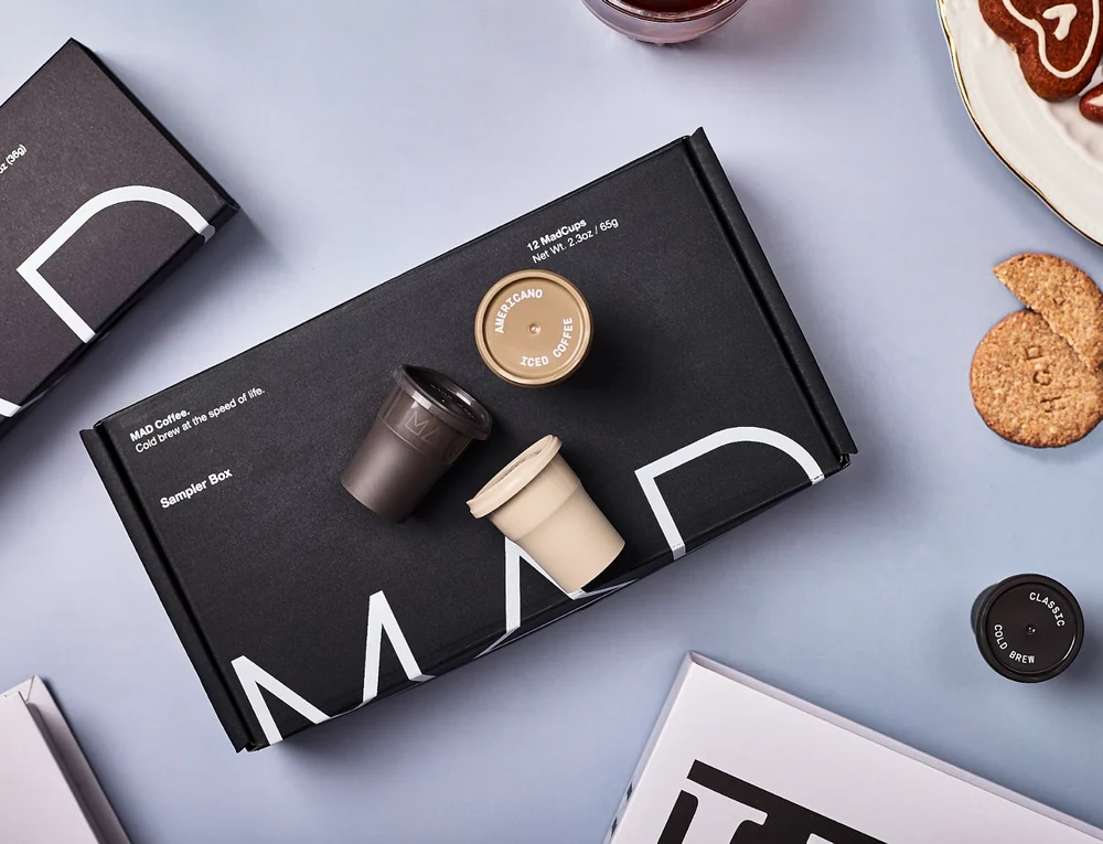 Mad Coffee packaging arranged with coffee-making accessories